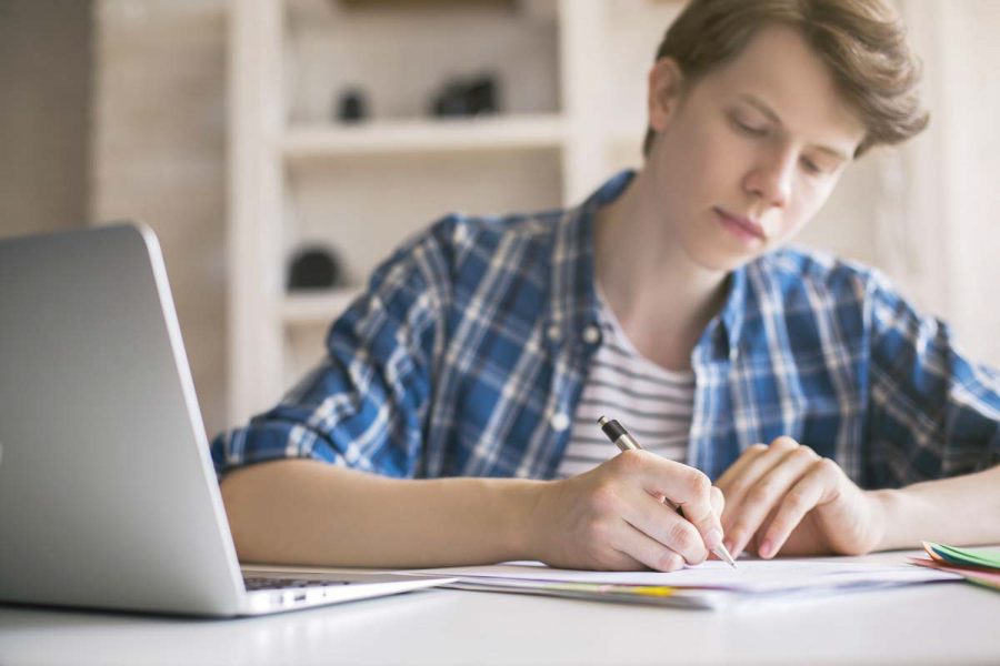 Young man writing essay