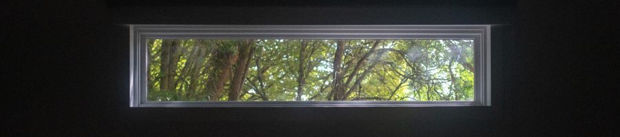 The newly installed window in Kent-Evans, casting a soft, natural light over the overwise dark auditorium.