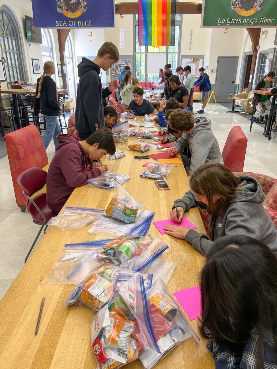 Advisory groups pack bags of supplies and cards during the 2022 9th grade day of service