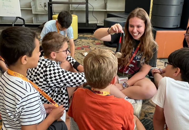 Mica Ruthfield 23 tests a camper-created mock hypnosis device at Lakesides Investigative Learning Camp (Betsmona A. 25)