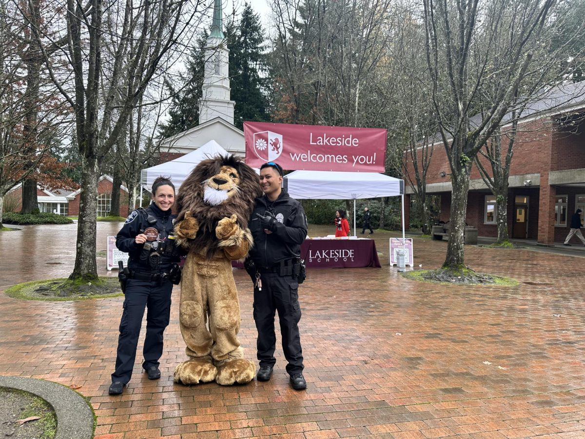 Officer Balter and Officer Daranciang pose for a photo with the Lakeside Lion at the admissions department’s open house.